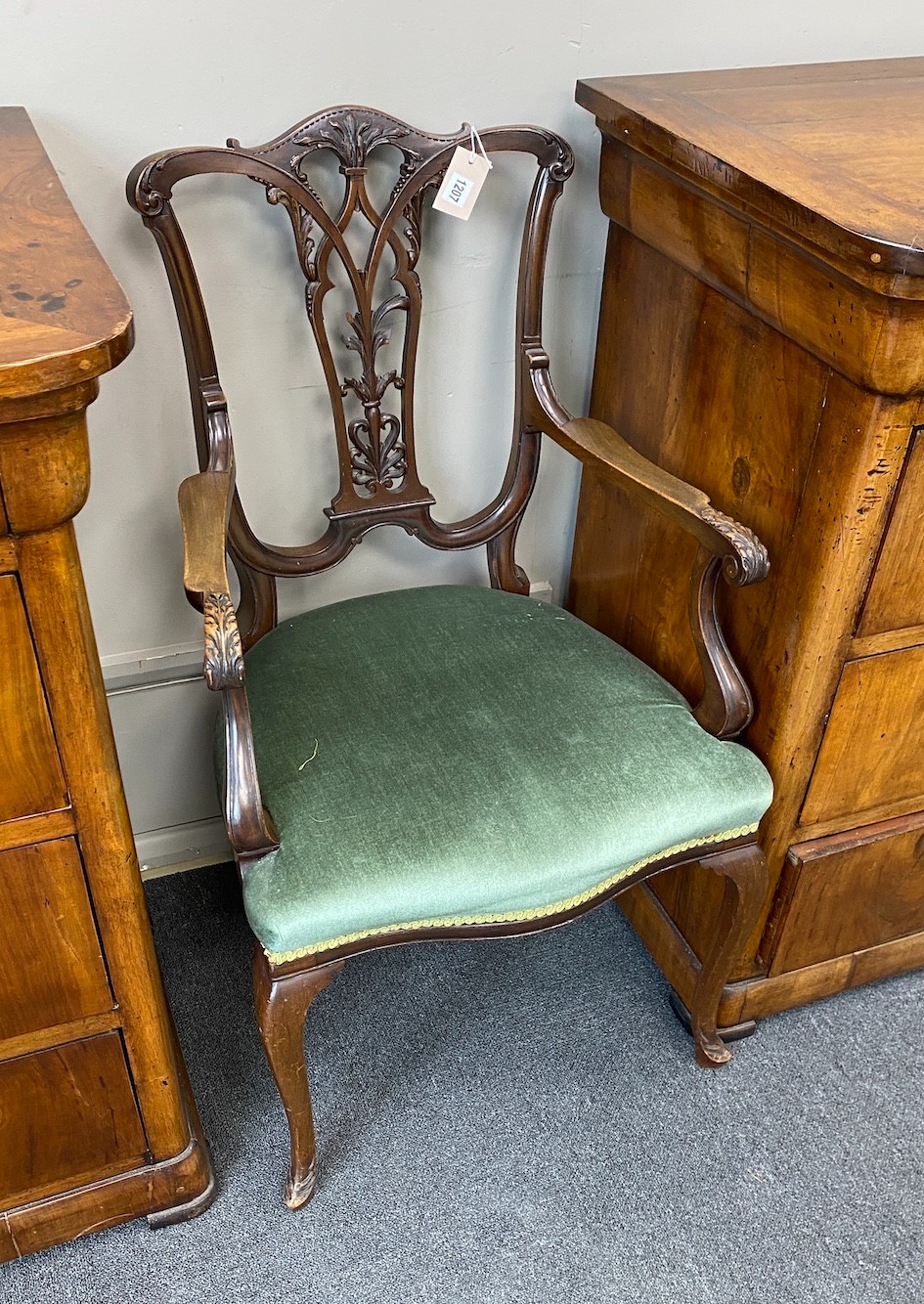 An Edwardian Chippendale style carved mahogany elbow chair